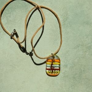 Necklace with colourful glass bead. Cyclist on a string.